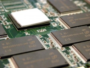 SSD NAND chips and controller on PCB close-up photo