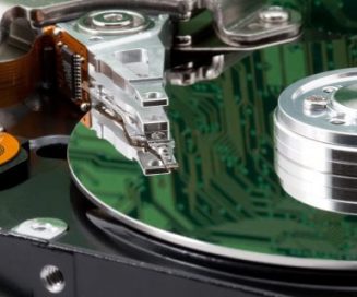 Hard disk platter and heads close-up with circuit reflection