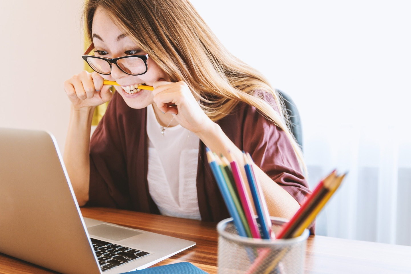 Frustrated computer user biting pencil