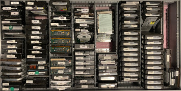 drawer full of Western Digital and Seagate hard drives on end