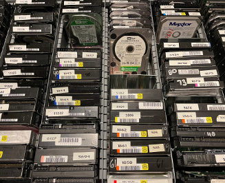 Drawer full of Maxtor and Western Digital hard drives on end
