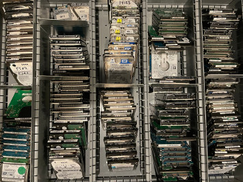 A drawer packed with HGST, Seagate, and Western Digital 2.5 inch hard drives